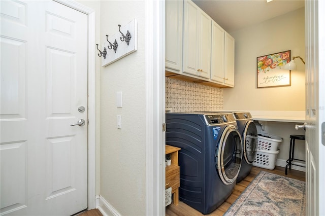 13235 Vennetta Way, Windermere, FL 34786 - laundry area with cabinet space, washing machine and clothes dryer, and light wood-type flooring