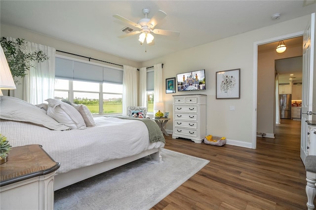 13235 Vennetta Way, Windermere, FL 34786 - bedroom with freestanding refrigerator, dark wood-type flooring, and ceiling fan