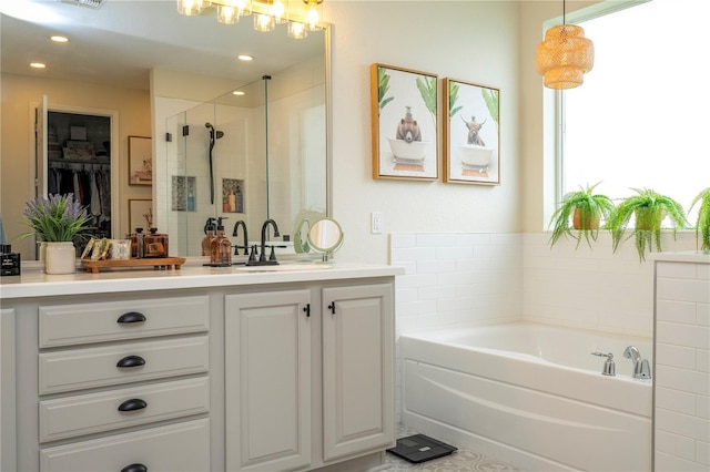 13235 Vennetta Way, Windermere, FL 34786 - full bathroom with a garden tub, vanity, a shower stall, a spacious closet, and a chandelier