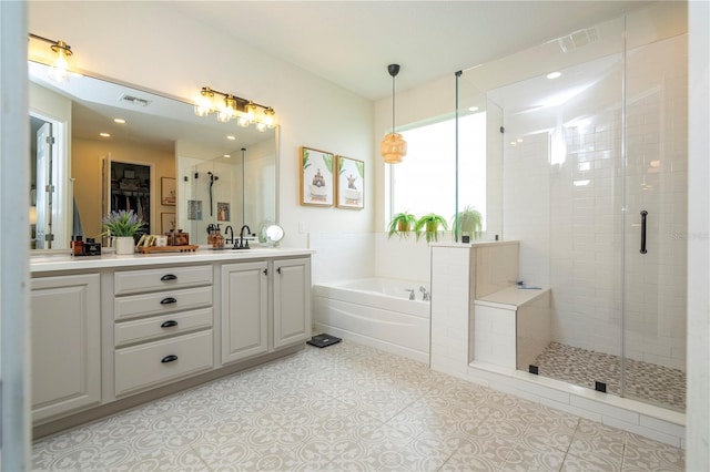 13235 Vennetta Way, Windermere, FL 34786 - full bathroom with double vanity, a shower stall, a garden tub, a walk in closet, and tile patterned flooring