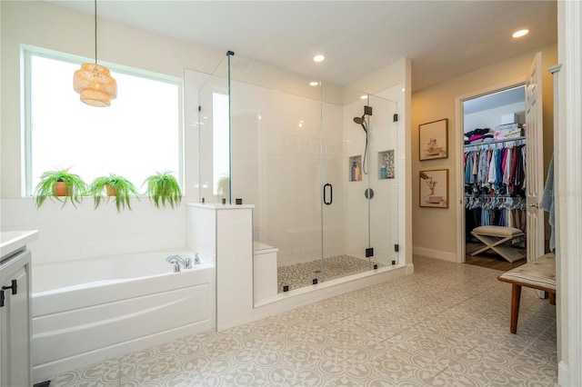 13235 Vennetta Way, Windermere, FL 34786 - full bathroom featuring a stall shower, a garden tub, vanity, a spacious closet, and recessed lighting