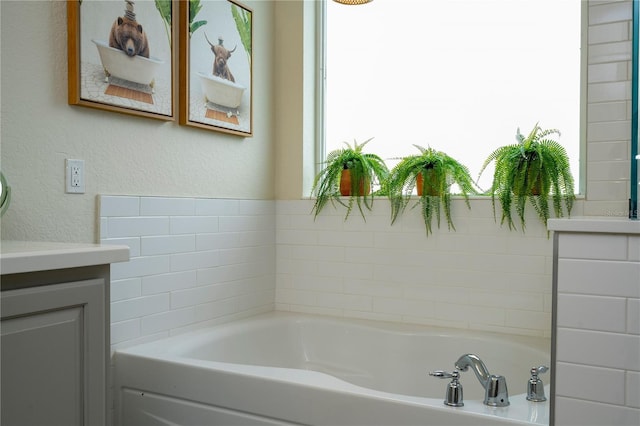 13235 Vennetta Way, Windermere, FL 34786 - bathroom featuring vanity, a bath, and a textured wall
