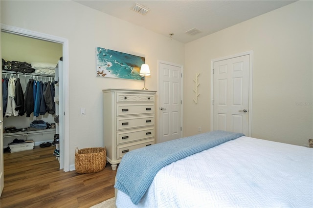 13235 Vennetta Way, Windermere, FL 34786 - bedroom with wood finished floors and a walk in closet