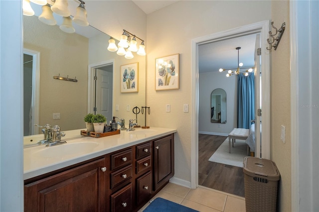 13235 Vennetta Way, Windermere, FL 34786 - bathroom featuring a chandelier, double vanity, and tile patterned flooring