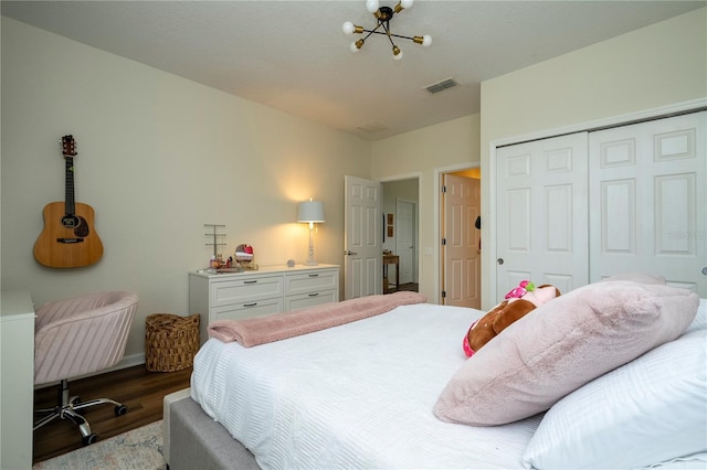 13235 Vennetta Way, Windermere, FL 34786 - bedroom with wood finished floors, a chandelier, and a closet
