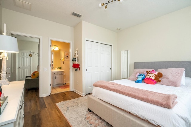 13235 Vennetta Way, Windermere, FL 34786 - bedroom with dark wood-type flooring, a closet, and ensuite bathroom