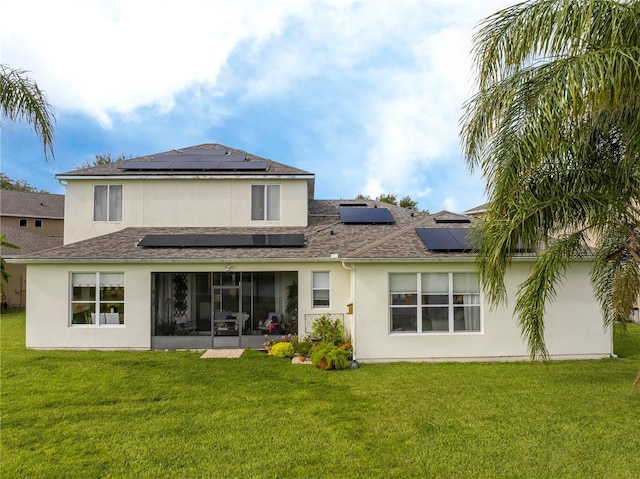 13235 Vennetta Way, Windermere, FL 34786 - rear view of house featuring roof mounted solar panels, stucco siding, a yard, a sunroom, and roof with shingles