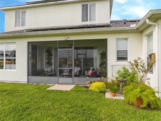 13235 Vennetta Way, Windermere, FL 34786 - back of property featuring a sunroom, stucco siding, and roof mounted solar panels