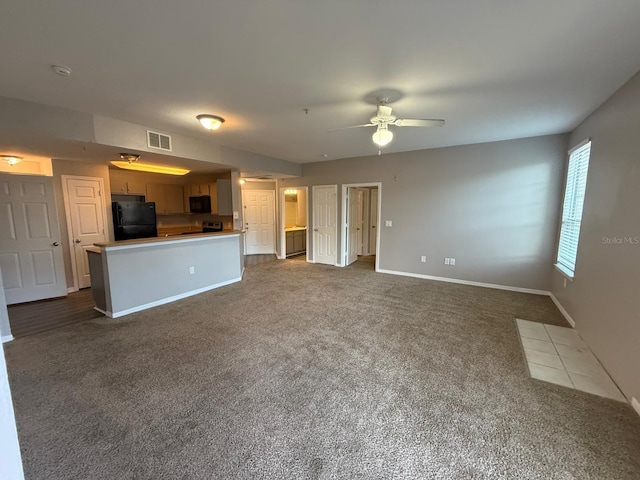 2015 Erving Cir Unit 307, Ocoee, FL 34761 - unfurnished living room with dark colored carpet and a ceiling fan