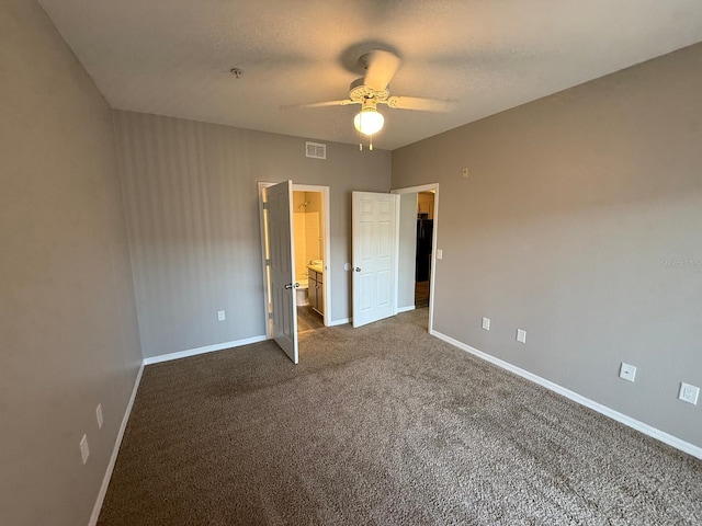 2015 Erving Cir Unit 307, Ocoee, FL 34761 - unfurnished bedroom with dark carpet, ceiling fan, and ensuite bath