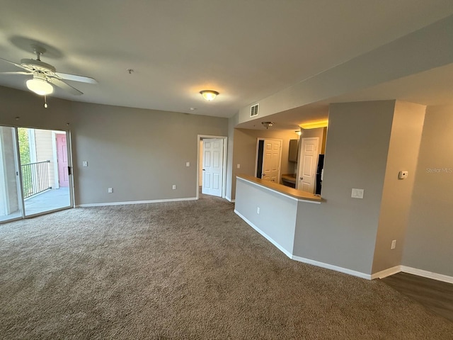 2015 Erving Cir Unit 307, Ocoee, FL 34761 - unfurnished living room featuring ceiling fan and dark colored carpet