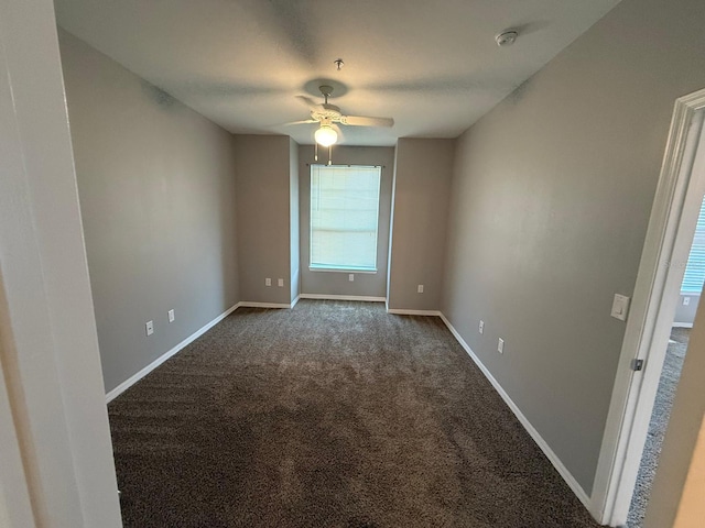 2015 Erving Cir Unit 307, Ocoee, FL 34761 - spare room featuring ceiling fan, a smoke detector, and dark carpet