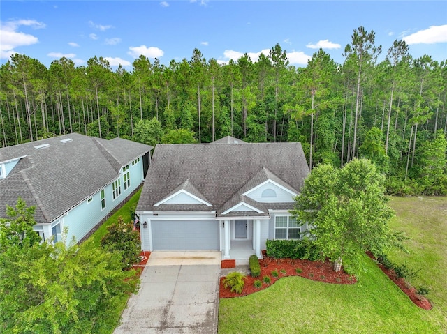 297 Shadow Ridge Trl, Ponte Vedra, FL 32081 - view of front facade with an attached garage, a wooded view, driveway, and a front lawn