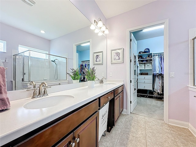 297 Shadow Ridge Trl, Ponte Vedra, FL 32081 - bathroom featuring double vanity, a walk in closet, tile patterned floors, and a stall shower