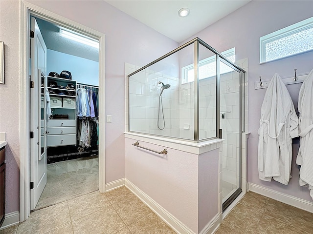 297 Shadow Ridge Trl, Ponte Vedra, FL 32081 - bathroom with a walk in closet, a stall shower, tile patterned flooring, and vanity