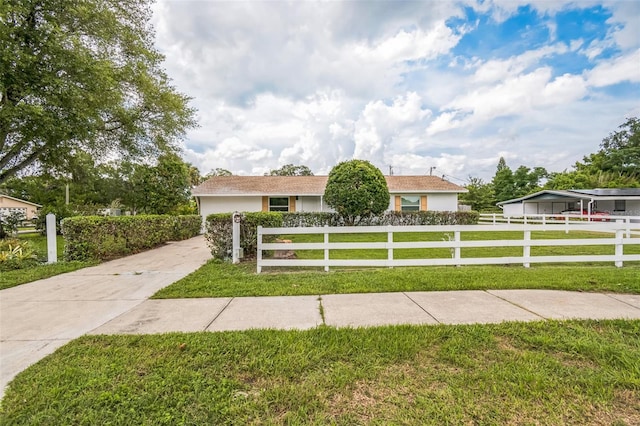 201 E 7th St, Chuluota, FL 32766 - view of front of property featuring driveway, a fenced front yard, stucco siding, and a garage
