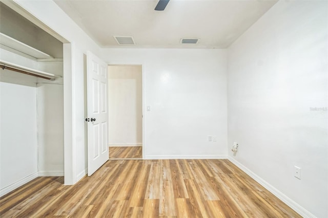 201 E 7th St, Chuluota, FL 32766 - unfurnished bedroom featuring light wood-style floors, a closet, and a ceiling fan