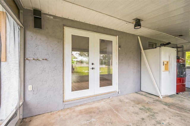 201 E 7th St, Chuluota, FL 32766 - entrance to property featuring french doors, stucco siding, a patio area, and washer and dryer