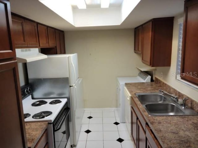 4322 Lakeway Dr Unit 13F, Orlando, FL 32839 - kitchen with white range with electric stovetop, washer and clothes dryer, ventilation hood, light tile patterned flooring, and a raised ceiling