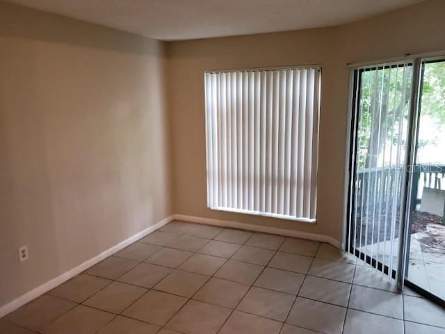 4322 Lakeway Dr Unit 13F, Orlando, FL 32839 - unfurnished room with light tile patterned flooring and baseboards