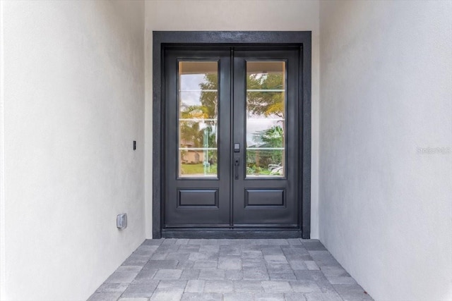 17 Old Oak Dr N, Palm Coast, FL 32137 - view of exterior entry featuring french doors and stucco siding