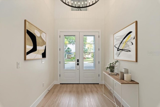 17 Old Oak Dr N, Palm Coast, FL 32137 - foyer entrance with french doors, light wood finished floors, a chandelier, and a high ceiling