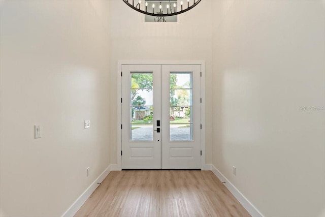 17 Old Oak Dr N, Palm Coast, FL 32137 - doorway to outside with french doors, light wood finished floors, a towering ceiling, and a chandelier