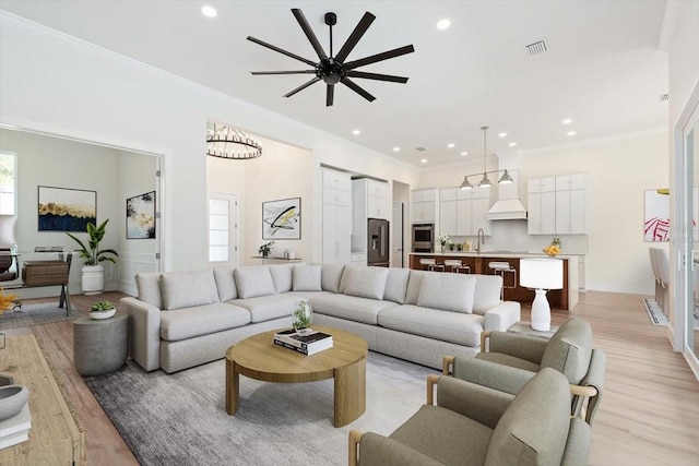 17 Old Oak Dr N, Palm Coast, FL 32137 - living room featuring ornamental molding, light wood-style floors, recessed lighting, and a ceiling fan