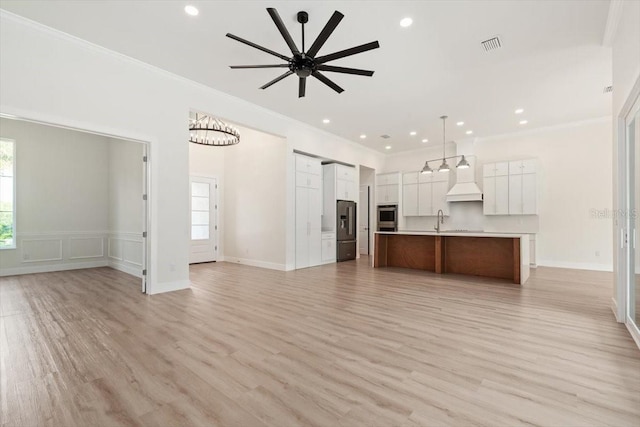 17 Old Oak Dr N, Palm Coast, FL 32137 - kitchen with open floor plan, fridge with ice dispenser, plenty of natural light, ornamental molding, and recessed lighting