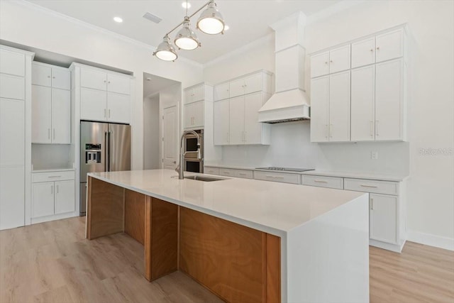 17 Old Oak Dr N, Palm Coast, FL 32137 - kitchen featuring appliances with stainless steel finishes, light wood-type flooring, premium range hood, crown molding, and a spacious island