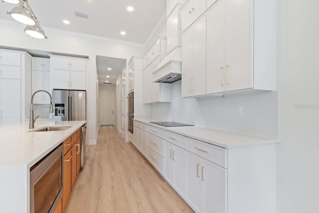 17 Old Oak Dr N, Palm Coast, FL 32137 - kitchen with appliances with stainless steel finishes, light countertops, light wood-style floors, ornamental molding, and white cabinets