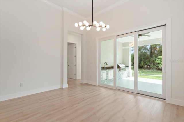 17 Old Oak Dr N, Palm Coast, FL 32137 - unfurnished dining area featuring light wood-type flooring, a chandelier, and ornamental molding