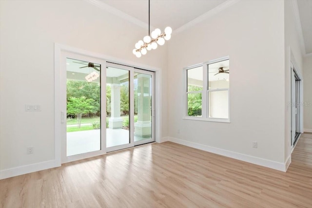 17 Old Oak Dr N, Palm Coast, FL 32137 - unfurnished room featuring light wood-style floors, crown molding, a ceiling fan, and a chandelier