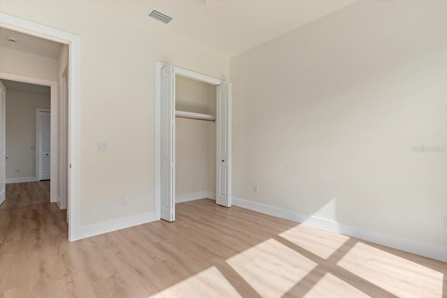 17 Old Oak Dr N, Palm Coast, FL 32137 - unfurnished bedroom with light wood-type flooring and a closet