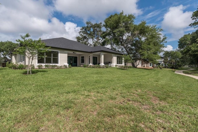 17 Old Oak Dr N, Palm Coast, FL 32137 - rear view of property featuring a yard