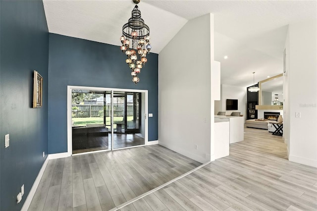 960 Falls Trl, Malabar, FL 32950 - unfurnished dining area featuring high vaulted ceiling, wood finished floors, and a chandelier