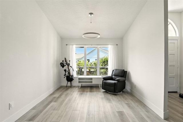 960 Falls Trl, Malabar, FL 32950 - sitting room with light wood-style flooring and a textured ceiling