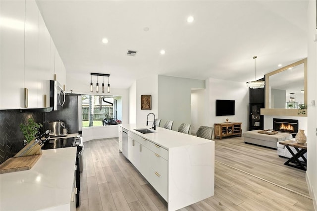 960 Falls Trl, Malabar, FL 32950 - kitchen with appliances with stainless steel finishes, modern cabinets, hanging light fixtures, white cabinets, and recessed lighting