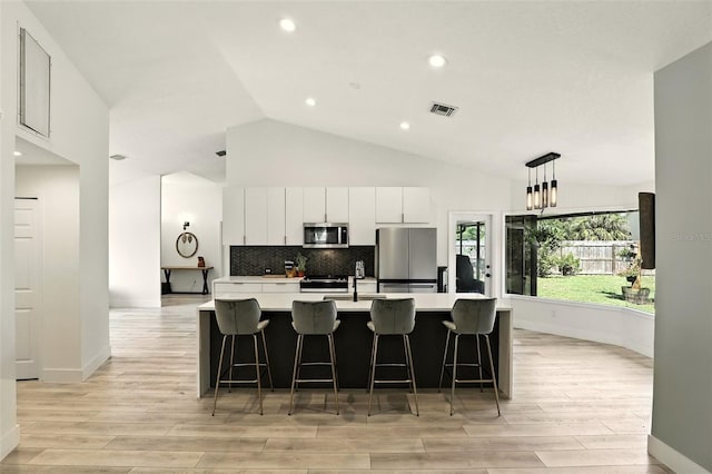 960 Falls Trl, Malabar, FL 32950 - kitchen featuring appliances with stainless steel finishes, light wood finished floors, light countertops, backsplash, and recessed lighting
