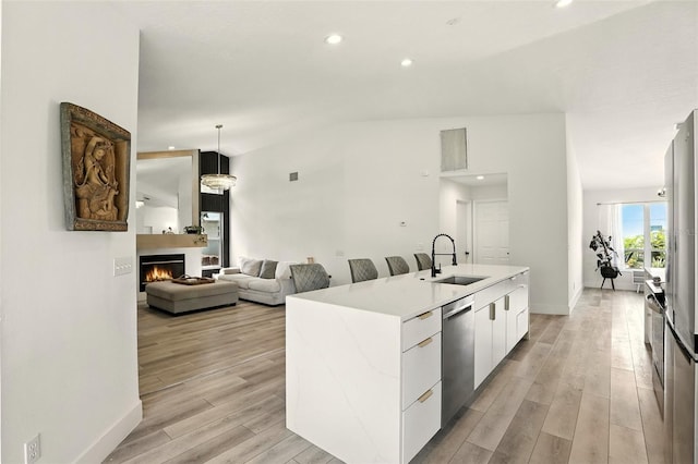 960 Falls Trl, Malabar, FL 32950 - kitchen featuring dishwasher, modern cabinets, a kitchen island with sink, light wood finished floors, and white cabinetry