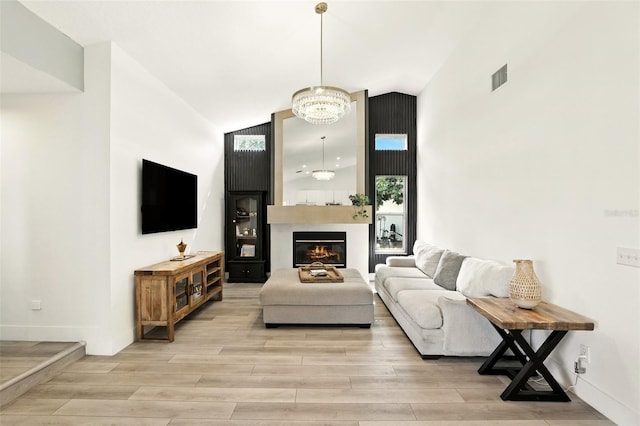 960 Falls Trl, Malabar, FL 32950 - living room featuring a chandelier, light wood-style flooring, and a fireplace