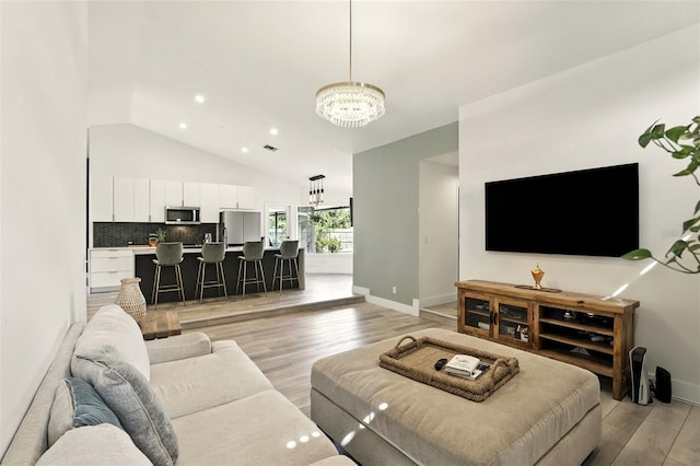 960 Falls Trl, Malabar, FL 32950 - living area featuring a chandelier, light wood-type flooring, lofted ceiling, and recessed lighting