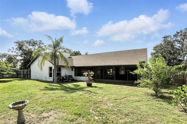960 Falls Trl, Malabar, FL 32950 - back of property featuring a sunroom, a fenced backyard, stucco siding, and a shingled roof