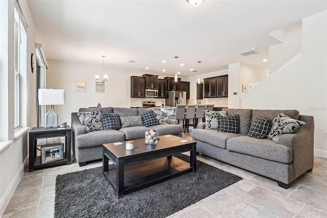 1833 Benoit Ter, Davenport, FL 33837 - living room featuring a chandelier and recessed lighting