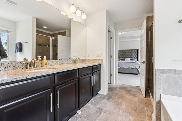 1833 Benoit Ter, Davenport, FL 33837 - ensuite bathroom with double vanity, a shower stall, a bathtub, and stone finish floors