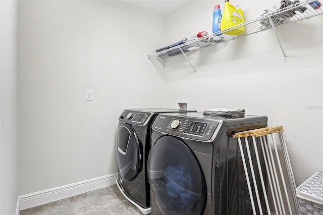 1833 Benoit Ter, Davenport, FL 33837 - laundry room with washer and clothes dryer and baseboards