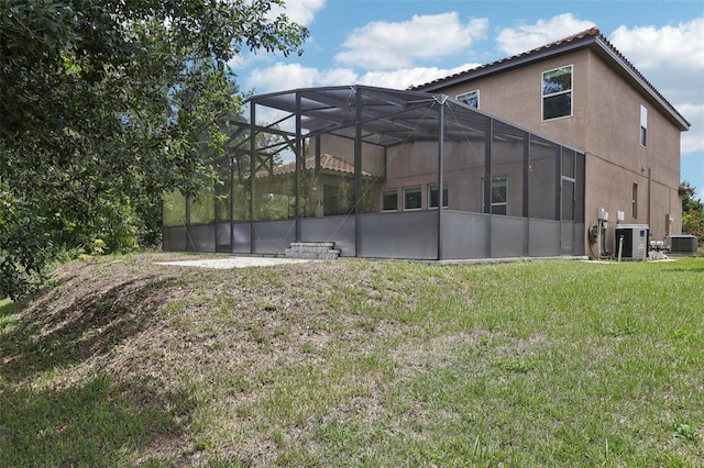1833 Benoit Ter, Davenport, FL 33837 - back of property featuring stucco siding, a lawn, and a lanai