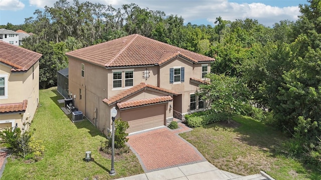 1833 Benoit Ter, Davenport, FL 33837 - mediterranean / spanish home with decorative driveway, a tiled roof, stucco siding, an attached garage, and a front yard