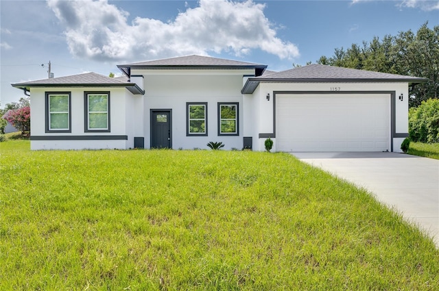 1157 W Hancock Dr, Deltona, FL 32725 - prairie-style house with stucco siding, an attached garage, a front lawn, and driveway