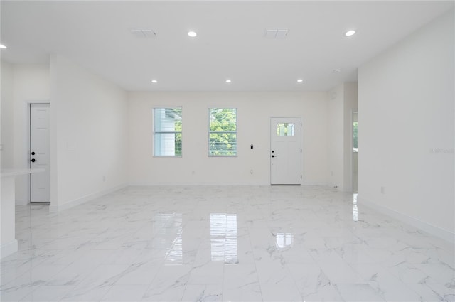 1157 W Hancock Dr, Deltona, FL 32725 - unfurnished living room with recessed lighting and light marble finish flooring